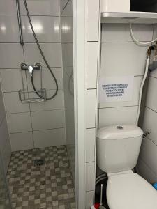 a small bathroom with a toilet and a shower at Studio cocooning cap d’Agde in Cap d'Agde +6 photos