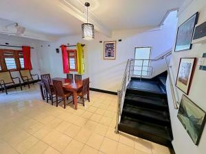 a dining room with a table and a stairway at PLACE 236 in Kandy