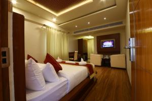 a hotel room with a bed and a television at Royal Stay in Bengaluru