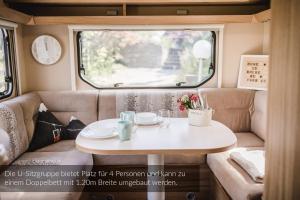 a table in the back of a campervan with a window at Strandbad Steckborn mit Herberge, Camping & Glamping in Steckborn