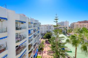 an aerial view of a building and a beach at weforyou Fuengirola Center Sunny & Beach in Fuengirola