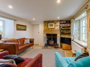 a living room with a couch and a fireplace at 3 Bed in Isle of Purbeck IC081 in Langton Matravers