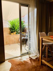um quarto com uma porta de vidro deslizante para um pátio em Lux and Cozy apartment em Los Cristianos