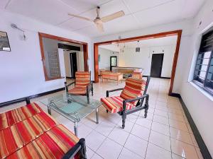 a living room with several chairs and a table at PLACE 236 in Kandy