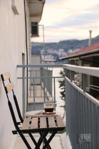 a cup of coffee sitting on a table on a balcony at Avra Studio Kastoria in Kastoria