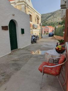 a table with a bowl of fruit on top of it at Aggeliki's House in Symi