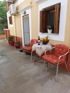 a table with two chairs and a bottle of wine at Aggeliki's House in Symi +23 photos