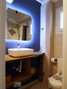 a bathroom with a sink and a mirror at Avra Studio Kastoria in Kastoria