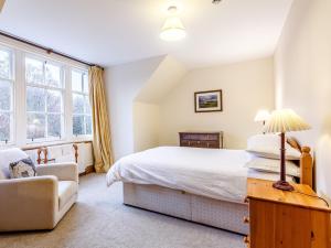 a bedroom with a bed and a chair at 6 Bed in Lairg CA210 