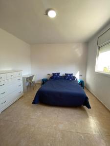 a bedroom with a bed and a desk and a window at CAN TRULLEN CHALET CALAFELL in Calafell