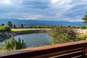 a view of a pond in a park with a bench at Martini villa Lake in Razlog