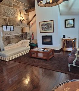 a living room with a couch and a coffee table at Solar de Almeidinha in Mangualde