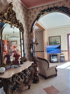 a living room with a large mirror and a couch at Villa Rosa in SantʼElia