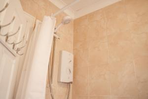 a shower in a bathroom with a shower curtain at Spacious 4 bed Edwardian home in Chester - Sleeps up to 7 in Chester