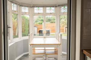 a room with a table in front of a window at Spacious 4 bed Edwardian home in Chester - Sleeps up to 7 in Chester