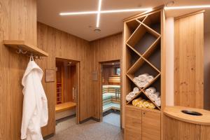 a bathroom with wooden walls and a walk in closet at Hotel Zum Schwarzen Bären in Emmersdorf an der Donau +37 photos