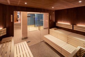 a sauna with benches and a walk in shower at Hotel Zum Schwarzen Bären in Emmersdorf an der Donau