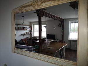 Vintage & Cozy Apartment في فاراجدين: مرآة تعكس غرفة المعيشة مع طاولة