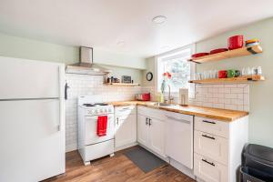 a kitchen with white appliances and a white refrigerator at State Street Cottage, Suite 1 in Pullman