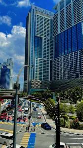a busy city with tall buildings and a street with cars at Vinson Suites at Platinum KLCC in Kuala Lumpur