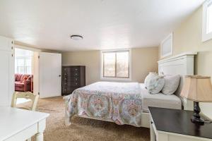 a bedroom with a bed and a desk with a lamp at State Street Cottage, Suite 1 in Pullman