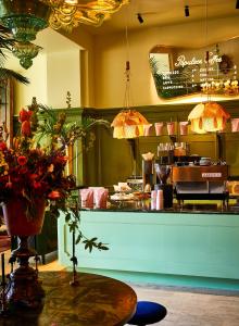 a restaurant with a table with flowers on it at The Siren Hotel in Detroit