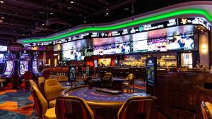 a casino with a bar and poker tables and chairs at Spokane Tribe Resort and Casino in Airway Heights