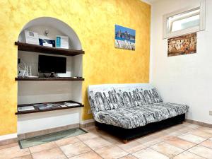 a living room with a couch and a tv at Il Rifugio Del Marinaio By Housilia in Cefalù