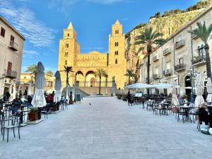 an empty street with tables and chairs in front of a church at Il Rifugio Del Marinaio By Housilia in Cefalù