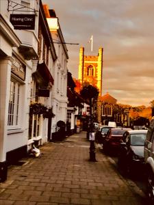 a city street with a clock tower in the distance at The number one in Henley on Thames