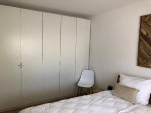 a bedroom with white cabinets and a white bed at Amselnest - b42499 in Rimsting