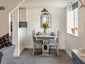 a dining room with a table with a vase of flowers at 2 Bed in Westward Ho 46824 in Westward Ho