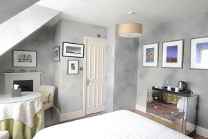 a room with a bed and a table and a staircase at The Cloudesley Guesthouse in Hastings