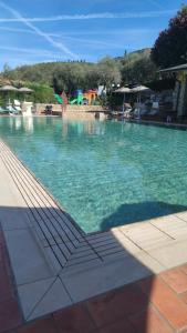 a large swimming pool with blue clear water at Campeggio Gianna Golfo dei Poeti in Lerici