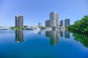 a view of a city from a river with buildings at Lux Condo at Yacht Club 10 min from Beach in Miami