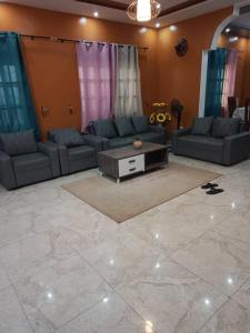 a living room with couches and a coffee table at Timba-Day229 in Abomey-Calavi