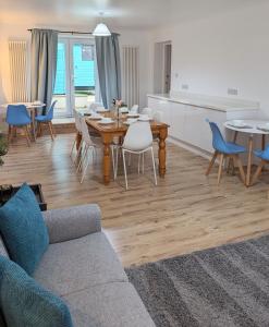 a living room with a couch and a table and chairs at Erradale in Campbeltown