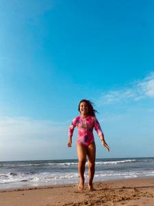 a young girl running on the beach at casaNorte paraíso norteño mirador de Ballenas in Canoas De Punta Sal