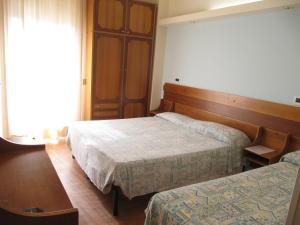 Postel nebo postele na pokoji v ubytování Hotel Sirena