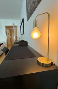 a desk with a lamp on top of it at Lovely Apartment at Quinta da Portela - Coimbra in Coimbra