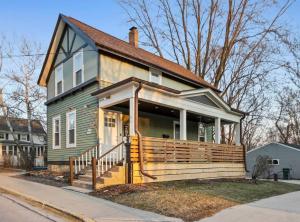 een klein groen huis met een veranda in een straat bij Chic Loft w/Parking 15 Mins to Little Switzerland in Germantown