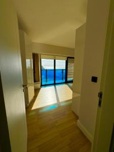 an empty hallway with a view of the ocean at Luxsor Rooms In Orbi City in Batumi