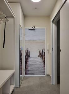 a hallway with a view of the beach from a house at Austernfischer - b63685 in Wendtorf