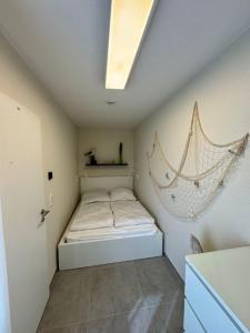 a bedroom with a bed with a hammock on the wall at Austernfischer - b63685 in Wendtorf
