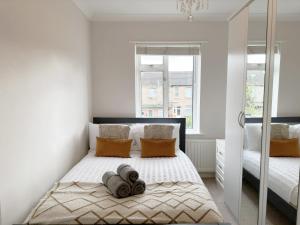 En eller flere senge i et værelse på Enchanting 3Bed, 2 Reception Apartment w/ Private Garden & Parking in Ilford