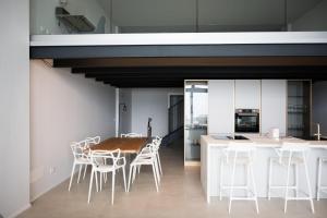 a kitchen and dining room with a table and chairs at Panorama Loft Apartments in Stresa