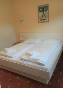 a large white bed in a room with a picture on the wall at Claire's Apartment in Wagrain