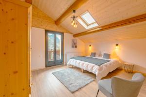 a bedroom with a bed and a skylight at Etoile des Vents in Morzine