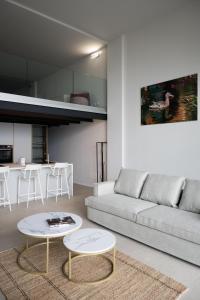 een woonkamer met een bank en een tafel bij Panorama Loft Apartments in Stresa