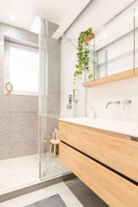 a bathroom with a tub and a sink and a shower at European heart 2-bedroom flat. in Brussels
